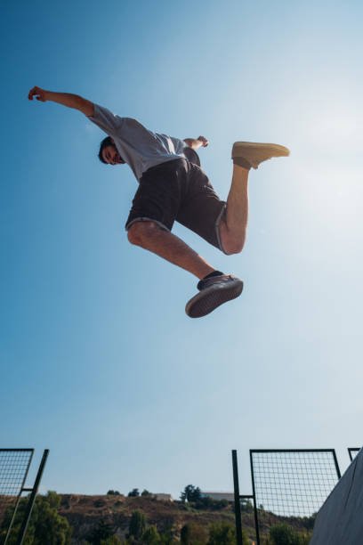 istock Sportive man in action while jump over obstacles 1370307605