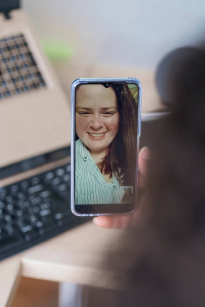istock Executive woman talking by video call with the client through her phone 1370307743