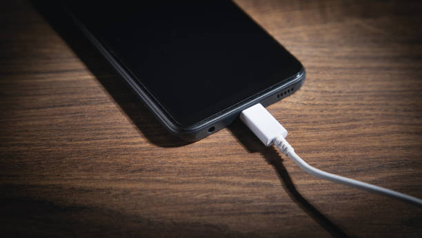 istock Smartphone charging battery on the wooden table. 1370307915