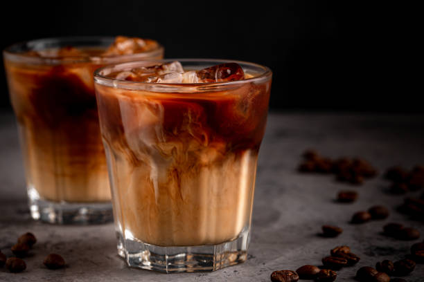istock Ice coffee in a glass with cream poured over 1370309396