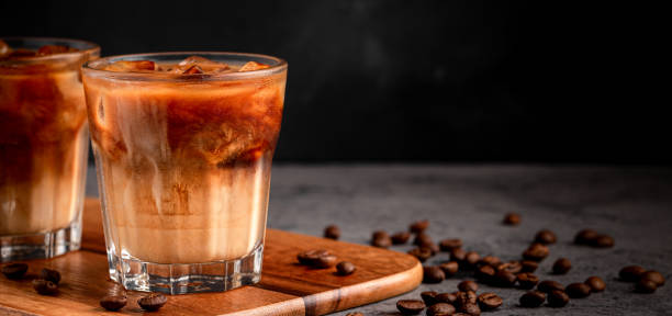 istock Ice coffee in a glass with cream poured over 1370309536