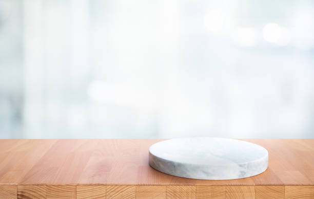istock Selective focus.Wood table top with chopping board with blur glass background. 1370311595
