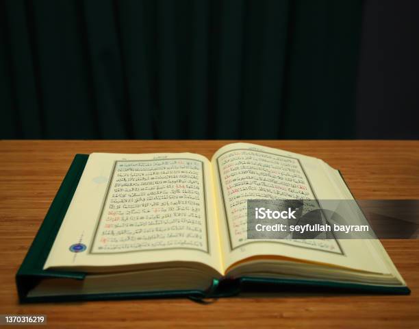 Opened Quran On Table Verses With Arabic Letter Stock Photo - Download Image Now - Sufism, Spirituality, Allah