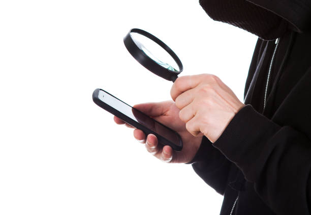 phone and magnifying glass - snooper imagens e fotografias de stock