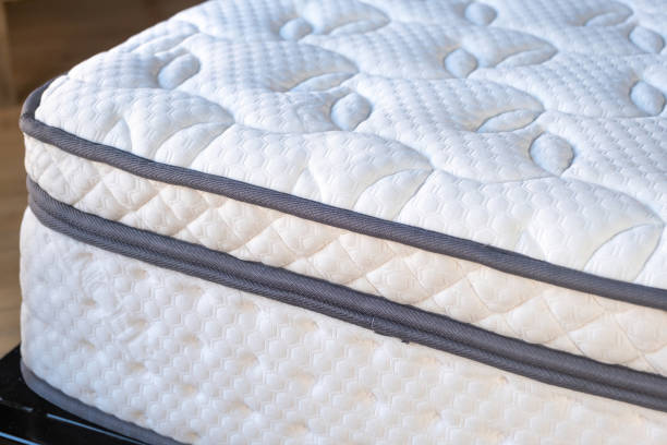 Mattress on a bed close up. Home bedroom interior detail, high angle view . Mattress orthopedic, new and clean on a bed close up view. Home bedroom, hotel room interior detail. Comfort and healthy sleep mattress stock pictures, royalty-free photos & images