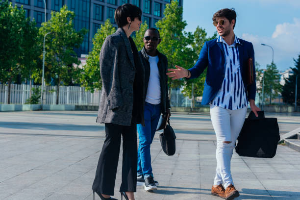 istock Group of successful business people discussing work outside their office building 1370324962