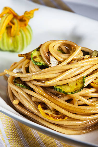 Whole-grain spagetti pasta with courgette stock photo