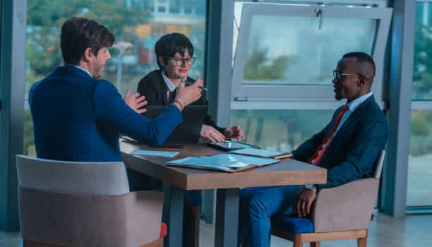 istock Multi-ethnic business people having discussion at conference table in office 1370325926