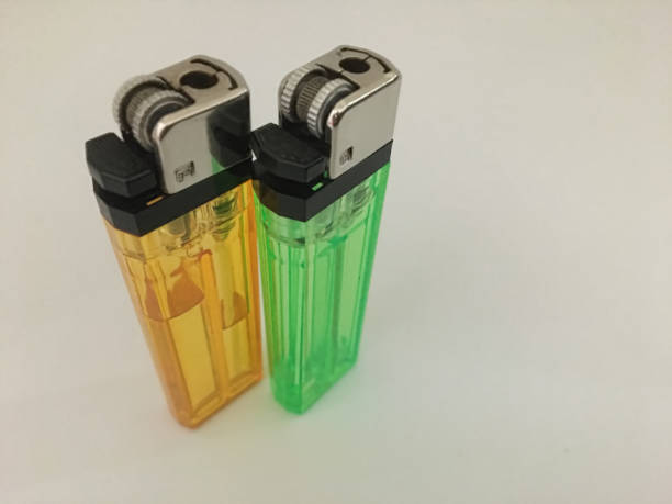 istock orange and green gas lighters on a plain background 1370329028