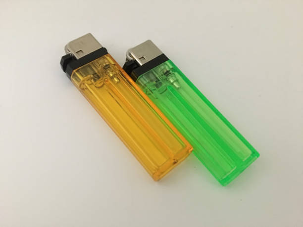 istock orange and green gas lighters on a plain background 1370329040