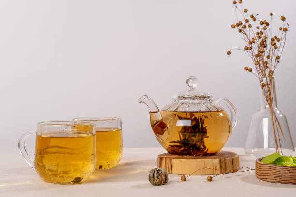 Green tea oolong in glass teapot on table. Hot tea is in the glass cups. Green tea oolong in glass teapot on table. Hot tea is in the glass cups.
Teapot and cup of tea with green tea on the table. Copy space. oolong tea stock pictures, royalty-free photos & images