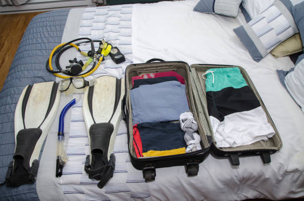 istock Suitcase with clothes and scuba gear 1370330775