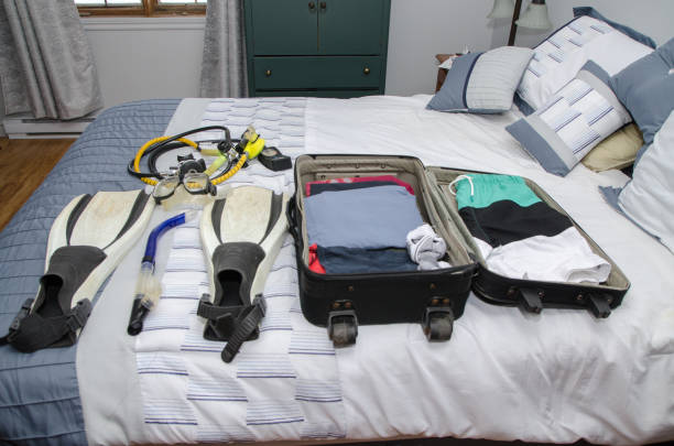 istock Suitcase with clothes and scuba gear 1370330790