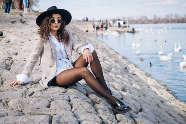 Beautiful fashion woman posing by the river