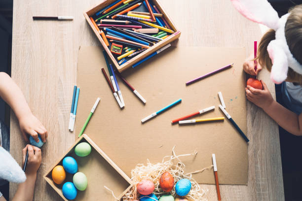 istock Children prepare for easter. Kids painting easter eggs. Easter background, flat lay, top view. 1370333327