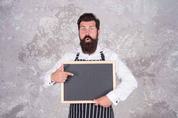 istock Master class from surprised cook man. best offer for dinner. chef baker menu. hospitable restaurant waiter with chalkboard, copy space. best choice. advertisement and food. cooking by recipe 1370334675