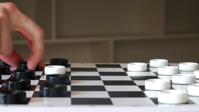 Two men playing checkers with each other