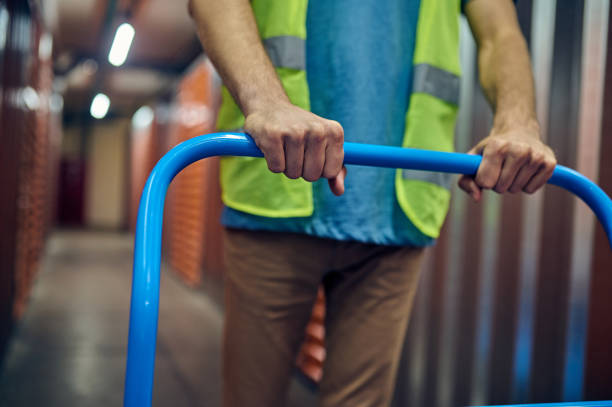 istock Caucasian worker pushing the warehouse cart ahead 1370336167