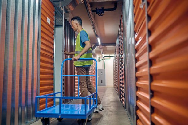 istock Male worker standing alone in the storehouse 1370336168