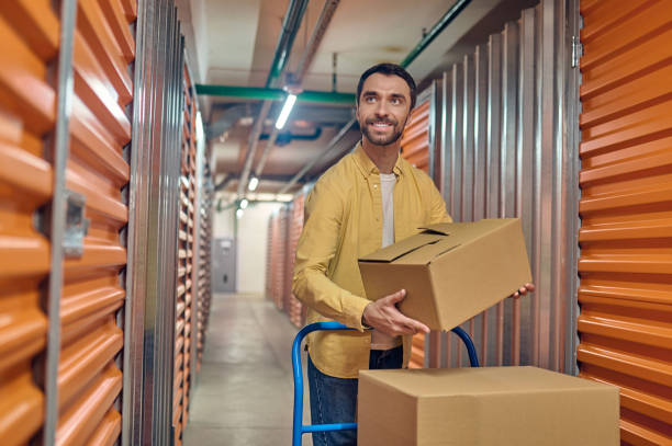 istock Joyous young male worker unloading items indoors 1370336185