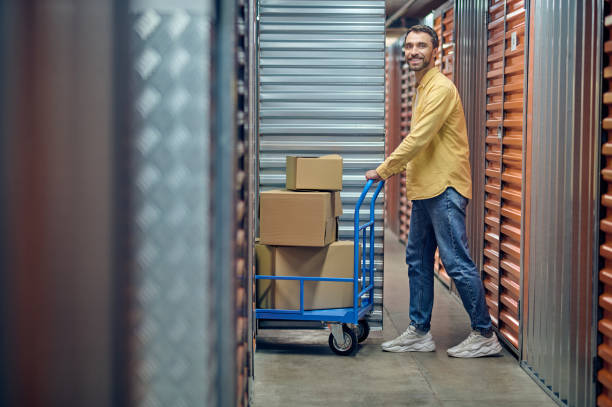istock Worker with the platform cart posing for the camera 1370336217