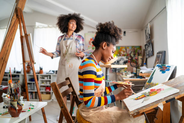 istock Afro female fine artists drawing in an art studio together 1370336322