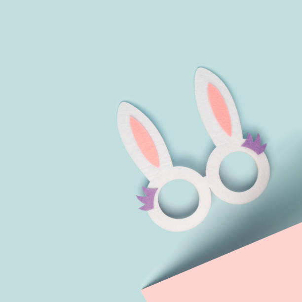 istock Rabbit ears celebration glasses on a two tone pastel background. 1370336857