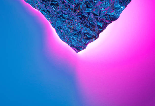 istock Crumpled aluminum foil with blue and pink light reflections. 1370338144