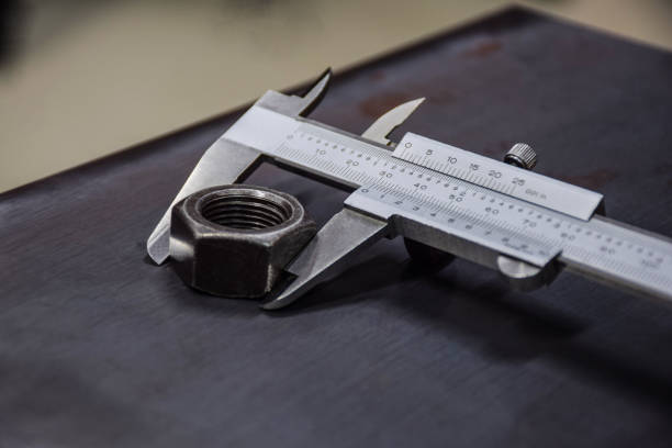 Vernier measures the nut size. Check the size and control the quality. Vernier measures the nut size. Check the size and control the quality.. micrometer screw gauge stock pictures, royalty-free photos & images