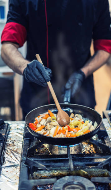 istock Close-up image of male chefs hands while cooking in the restaurant kitchen 1370338338