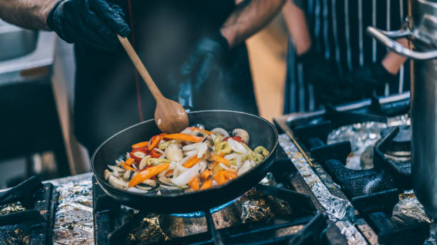 istock Close-up image of male chefs hands while cooking in the restaurant kitchen 1370338340
