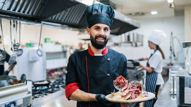 istock Male chef presenting meals at the restaurant kitchen 1370338343