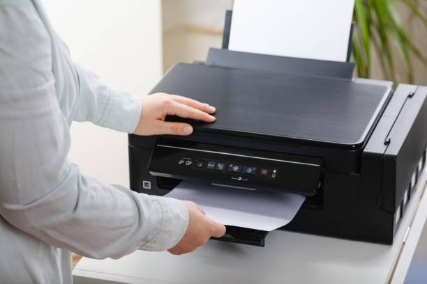 istock Office work. Secretary woman making a photocopy of important documents. Office manager using printer, scanner or laser copy machine. 1370339309