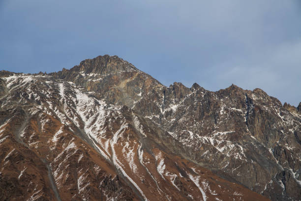 istock Beautiful winter mountains landscape. High snow covered rocks. 1370339427