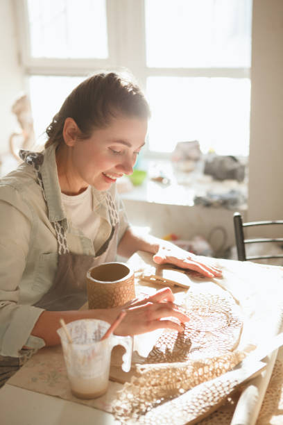 istock Woman enjoying learning pottery at art studio 1370341473