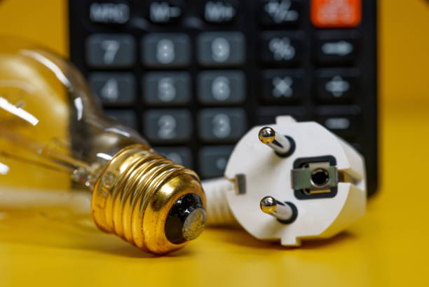istock Electricity growth concept. Calculator and AC power plug. 1370342258