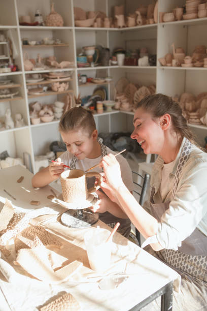 istock Mother and son enjoying making pottery together 1370342383