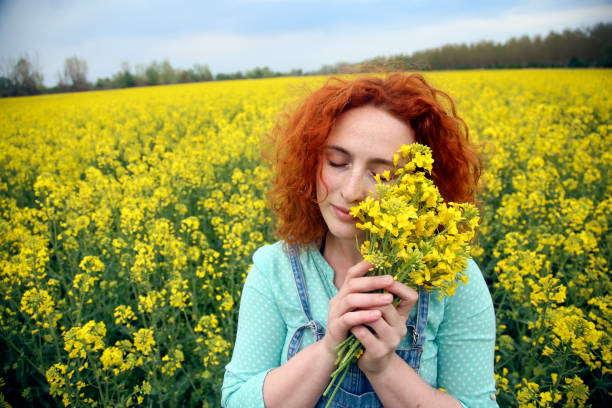 istock Young woman in a canola field 1370346657