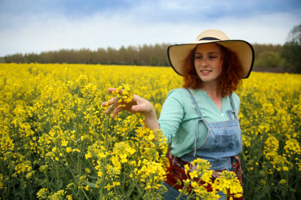 istock Young woman in a canola field 1370347198