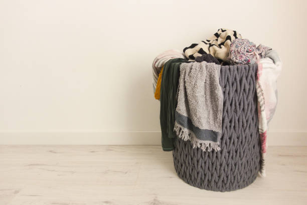 istock Wicker basket full of dirty laundry 1370347751