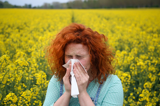 Young woman with pollen allergy. About 25 years, female Caucasian redhead.
