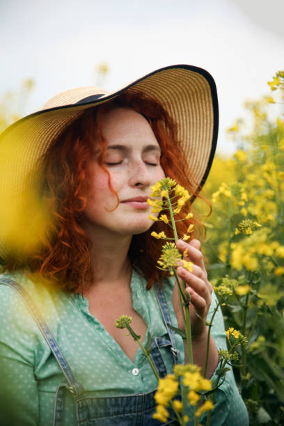 istock Young woman smelling flowers 1370347891