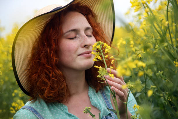 istock Young woman smelling flowers 1370347896