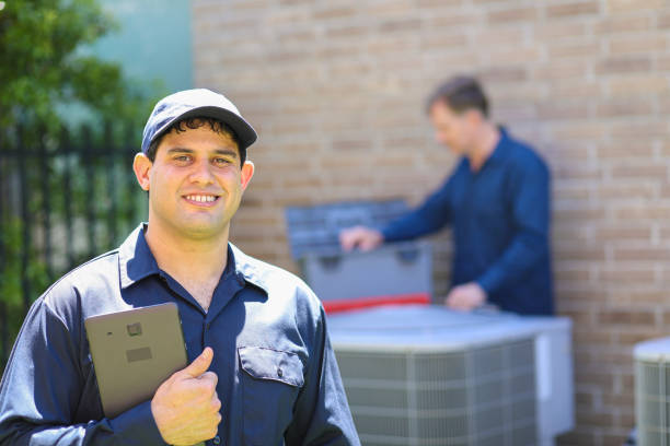 istock Multi-ethnic team of blue collar air conditioner repairmen at work. 1370348045