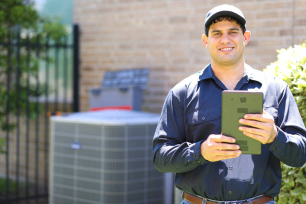istock Latin descent young man, blue collar air conditioner repairman at work. 1370348431