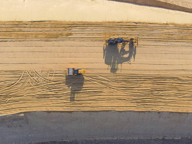 Construction roller and grader on sand, aerial view stock photo