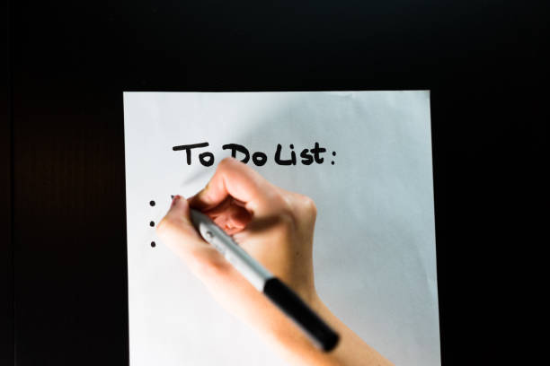 istock Making a list with goals or shopping list on white paper 1370349574