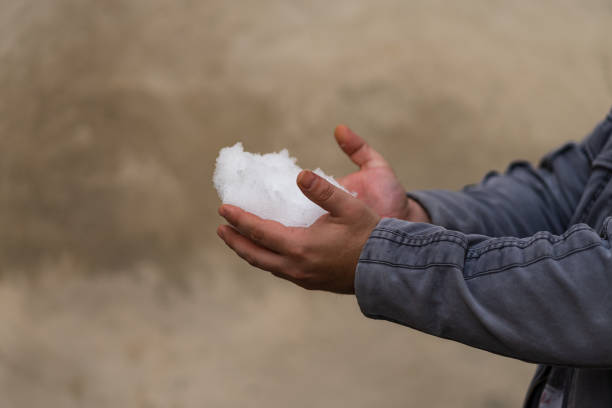 istock Man holding snow in his hands 1370352503