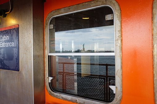 Reflection of Lady Liberty in the ferry´ s window  that goes from New York to New Jersey