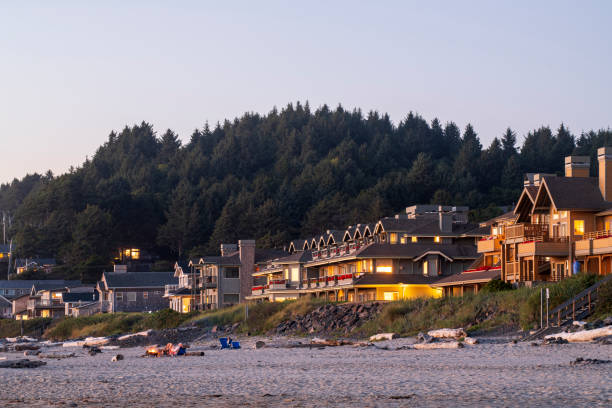 Cannon Beach, USA - September 6, 2021. People sitting on chairs on Cannon Beach, Oregon, USA
